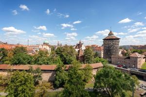 a view of a city with a tower and trees at Brera Nürnberg in Nürnberg
