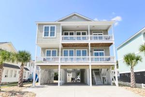 a house with palm trees in front of it at Anchor Down Luxury Ocean View Beach House w Pool in Myrtle Beach