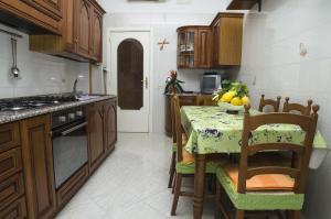 a kitchen with a table with a bowl of fruit on it at Casa Raffelina in Minori