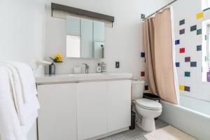 a white bathroom with a sink and a toilet at 4BR in the heart of Tribeca in New York