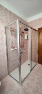 a shower with a glass door in a bathroom at Case Gioto e Bellavista in Passignano sul Trasimeno