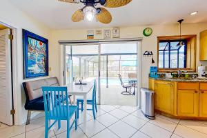 a kitchen and dining room with a table and chairs at Rock N' Reel Boat House in Saint James City