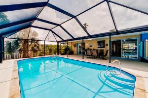 a large swimming pool with a large glass roof at Rock N' Reel Boat House in Saint James City