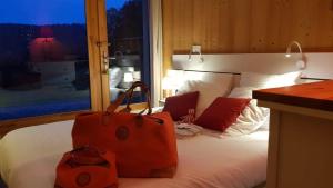 a bedroom with a bed with two bags on it at gite haut Jura in Chaux-des-Crotenay