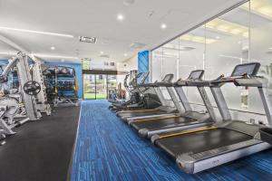 a gym with cardio equipment and treadmills at Style & Fantastic Apartment in Crystal City! in Arlington