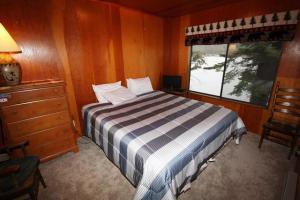 a bedroom with a bed and a window at 3 bedroom, 2 bath, sleeps 6 Donner Lakefront with private dock DLR#071 in Truckee