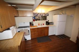 a kitchen with a white refrigerator and a sink at 3 bedroom, 2 bath, sleeps 6 Donner Lakefront with private dock DLR#071 in Truckee