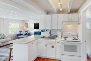 a kitchen with white cabinets and a sink at Sombrero Suite in Marathon