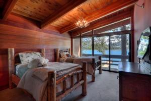 a bedroom with two beds and a large window at 3 bedroom and Den, 3 and a half bath, sleeps 12, Lakefront with private dock DLR#004 in Truckee