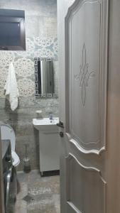 a bathroom with a toilet and a sink and a door at Orophile guest house in Gorists'ikhe +31 photos