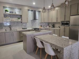 a kitchen with a large island with a counter top at Coral de Cortes - New Beach House in San Carlos