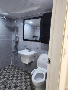 a bathroom with a toilet and a sink at Urbanspace Pohang in Pohang