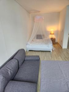 a living room with a couch and a bed at Urbanspace Pohang in Pohang