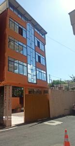 a building with an orange cone in front of it at Hotel Kurtabeg in Shkodër