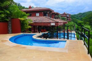 a swimming pool in front of a house at Bougainvillea 2101 in Playa Conchal