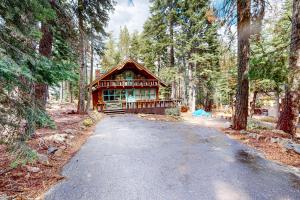 a log cabin in the middle of a forest at Pine Knolls in Tahoma