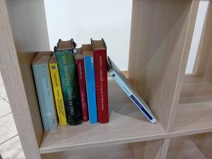 a book shelf with books and a pen on it at Casa vacanza Argo. Bovo marina/torre salsa in Montallegro