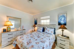 a bedroom with a bed and a dresser and a mirror at Pet-Friendly Venice Vacation Rental, 3 Mi to Beach in Venice