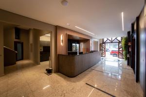 a lobby with a reception desk in a building at Luz Hotel Pato Branco in Pato Branco