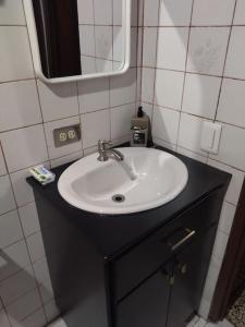 a bathroom with a sink and a mirror at Casa de campo en Río Cuarto in Río Cuarto