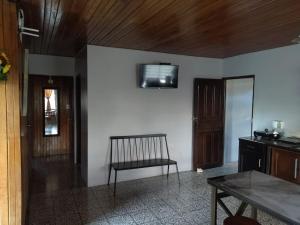 a living room with a chair and a television on a wall at Casa de campo en Río Cuarto in Río Cuarto