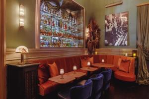 a restaurant with two tables and blue chairs at Soho Grand Hotel in New York