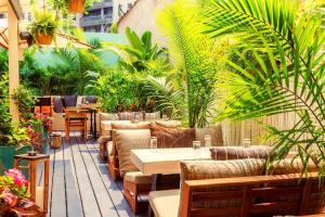 a patio with couches and tables and plants at Soho Grand Hotel in New York