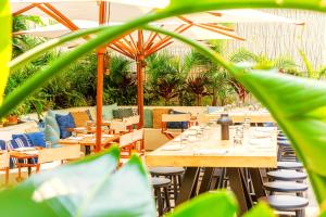 a restaurant with tables and chairs and plants at Soho Grand Hotel in New York