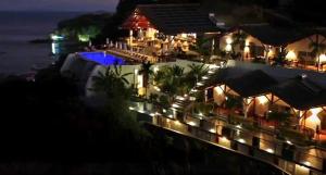 a view of a hotel at night with lights at Andriana Resort & Spa in Nosy Be