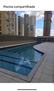a swimming pool on the roof of a building at Unique Residence, próximo ao Parque e Shopping Flamboyant in Goiânia