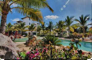 a resort with a swimming pool with palm trees and flowers at Luxury Apartment Dominicus in La Laguna