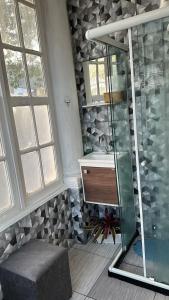 a bathroom with a glass shower and a sink at Hotel Cidade Imperial in Petrópolis