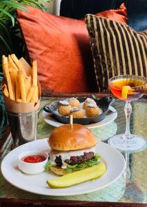 a table with two plates of food and french fries at Soho Grand Hotel in New York