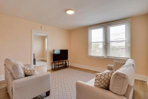 a living room with two chairs and a television at Hatboro Retreat Steps From Shopping and Dining! 