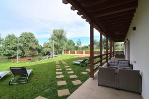 a patio with chairs and a view of a park at Eden Uzlina in Uzlina