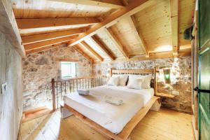 a bedroom with a bed in a room with wooden ceilings at Villa Teza Hvar in Hvar