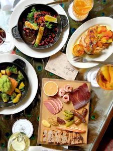 a table topped with plates of food and plates of food at Soho Grand Hotel in New York