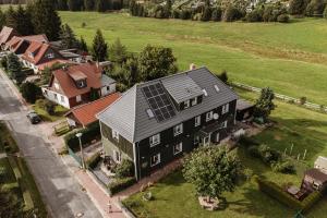 eine Luftansicht eines Hauses mit Solardach in der Unterkunft Waldrandzauber in Benneckenstein