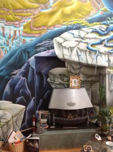a wall with a painting of a cave with a fireplace at Gîte Crystal Inn in Mont-Tremblant