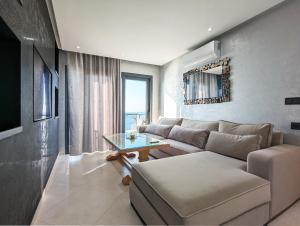 a living room with a couch and a table at RS Apartments - AL HOCEIMA in Al Hoceïma