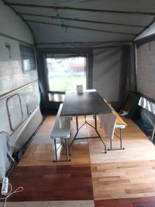 a table and two chairs in a tent at Kemping prywatny na ośrodku in Gąski