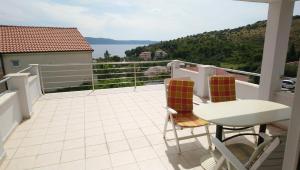 a balcony with a table and two chairs and a view at Apartmani ANDRIJA in Živogošće
