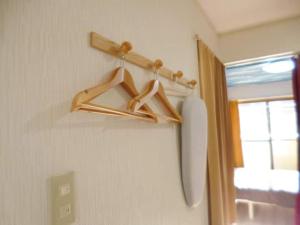 a wooden hanger on a wall next to a window at The Mickey Carlton Ohashi Alpha Coat - Vacation STAY 15164 in Fukuoka
