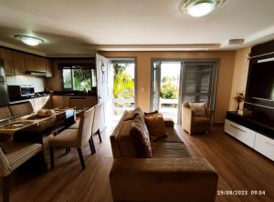 a kitchen and living room with a couch and a table at Casa com piscina e Quiosque! in Encantado
