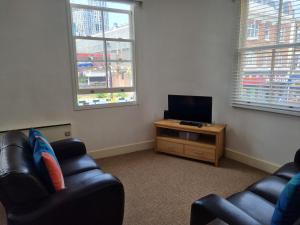 a living room with two chairs and a flat screen tv at Stunning 2 Bed/2 Bath Flat in Waterloo, London in London
