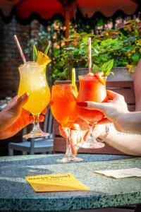 two people holding up two drinks on a table at Soho Grand Hotel in New York