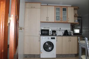 W kuchni znajduje się pralka i kuchenka mikrofalowa. w obiekcie CAMINO INGLES Habitación Luxe doble Baño y cocina w mieście A Coruña