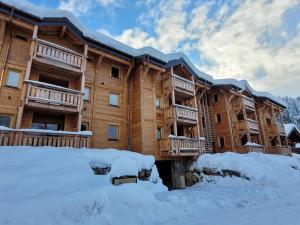 a large wooden building with snow in front of it at Appartement Les Gets, 3 pièces, 4 personnes - FR-1-598-93 in Les Gets