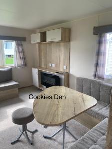 a living room with a table and a couch at Cookies Den in Weymouth