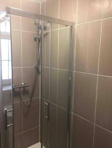 a shower with a glass door in a bathroom at APlaceToStay Central London apartment, Zone 1 LEIC in London